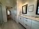Bright bathroom featuring double sinks, granite countertops, and tile flooring at 13133 Roseanna Dr, Spring Hill, FL 34609