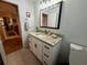 Bathroom featuring granite countertop and a white vanity, adjacent to the living area at 13133 Roseanna Dr, Spring Hill, FL 34609