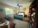 Cozy bedroom featuring a queen bed, large window and a sizable bookcase filled with books at 13133 Roseanna Dr, Spring Hill, FL 34609