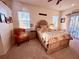 Cozy bedroom with an elegant accent chair, a comfortable bed and bright lighting at 13133 Roseanna Dr, Spring Hill, FL 34609