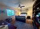 Comfortable bedroom with a queen bed, ceiling fan, and a large window offering natural light and outdoor views at 13133 Roseanna Dr, Spring Hill, FL 34609
