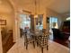 Charming breakfast nook with checkered chairs, a glass table, and views of the screened outdoor patio at 13133 Roseanna Dr, Spring Hill, FL 34609