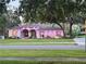 Charming single-story home with patriotic lights, manicured lawn, and mature trees at 13133 Roseanna Dr, Spring Hill, FL 34609