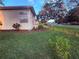 Well-manicured front yard featuring a lush lawn, decorative shrubs, and mulch beds accent the home's curb appeal at 13133 Roseanna Dr, Spring Hill, FL 34609