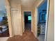 Inviting hallway with closet space leads to a living room and bathroom at 13133 Roseanna Dr, Spring Hill, FL 34609