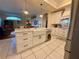 Bright kitchen featuring a large island with sink, stainless steel appliances and white cabinets at 13133 Roseanna Dr, Spring Hill, FL 34609