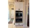 Kitchen wall cabinet with microwave, oven, and warming drawer at 13133 Roseanna Dr, Spring Hill, FL 34609