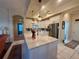 Bright kitchen featuring a large island with sink, stainless steel appliances and white cabinets at 13133 Roseanna Dr, Spring Hill, FL 34609