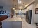 Bright kitchen featuring a large island with sink, stainless steel appliances and white cabinets at 13133 Roseanna Dr, Spring Hill, FL 34609