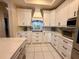 Efficient kitchen with white cabinets, granite countertops, and modern appliances at 13133 Roseanna Dr, Spring Hill, FL 34609