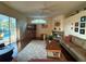 Inviting living room featuring a stone fireplace, wood floors, and a large window with a view of the pool at 13133 Roseanna Dr, Spring Hill, FL 34609