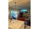 Bright living room showcasing wood floors, fireplace, and backyard views at 13133 Roseanna Dr, Spring Hill, FL 34609