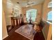Welcoming living room with hardwood floors, cozy seating, and natural light from a window at 13133 Roseanna Dr, Spring Hill, FL 34609