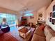 Bright living room showcasing wood floors, fireplace, and backyard views at 13133 Roseanna Dr, Spring Hill, FL 34609