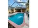 The backyard features a screened in pool with an outdoor living space and lush landscaping at 13133 Roseanna Dr, Spring Hill, FL 34609