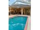 Backyard pool with covered patio, ceiling fans, outdoor seating, and outdoor lighting at 13133 Roseanna Dr, Spring Hill, FL 34609