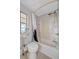 Clean bathroom featuring a tub with shower, a toilet, and white tiled walls at 134 W Saint Annes Cir, Apollo Beach, FL 33572