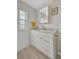 Bright bathroom with white marble countertops, modern fixtures, and stylish white cabinets at 134 W Saint Annes Cir, Apollo Beach, FL 33572