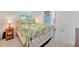 Inviting bedroom with tropical-patterned bedding and a lattice-style bed frame at 134 W Saint Annes Cir, Apollo Beach, FL 33572