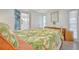 Comfortable bedroom featuring vibrant tropical bedding and ample natural light at 134 W Saint Annes Cir, Apollo Beach, FL 33572