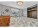 A well-lit bedroom featuring coastal decor, a window and a wardrobe at 134 W Saint Annes Cir, Apollo Beach, FL 33572