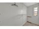 An empty walk-in closet with metal shelving and a small window at 134 W Saint Annes Cir, Apollo Beach, FL 33572