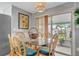 Cozy dining area with water view, rattan chairs and sliding glass doors at 134 W Saint Annes Cir, Apollo Beach, FL 33572