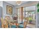 Cozy dining area with water view, rattan chairs and sliding glass doors at 134 W Saint Annes Cir, Apollo Beach, FL 33572
