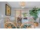 Bright dining room featuring rattan chairs, a glass table, and lots of greenery at 134 W Saint Annes Cir, Apollo Beach, FL 33572