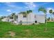 Exterior of the house with a small patio and lawn at 134 W Saint Annes Cir, Apollo Beach, FL 33572