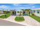 Charming home boasts a lovely, paved driveway, carport, and welcoming curb appeal under a bright sky at 134 W Saint Annes Cir, Apollo Beach, FL 33572