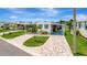 Charming home boasts a lovely, paved driveway, carport, and welcoming curb appeal under a bright sky at 134 W Saint Annes Cir, Apollo Beach, FL 33572