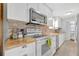 Well-lit kitchen with stainless steel appliances, wood countertops, and backsplash at 134 W Saint Annes Cir, Apollo Beach, FL 33572