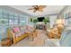Living area featuring comfortable wicker furniture and a stylish entertainment center at 134 W Saint Annes Cir, Apollo Beach, FL 33572