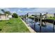Scenic view of a waterfront property with boat lifts and lush green landscaping at 134 W Saint Annes Cir, Apollo Beach, FL 33572