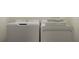 A laundry room features a modern washer and dryer with stacked towels on top at 13519 White Gold Run, Parrish, FL 34219