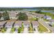 An aerial view of a well-planned residential community with scenic waterfront views and manicured lawns at 13765 Whiskey Daisy Dr, Dade City, FL 33525