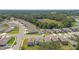 A beautiful aerial view showcasing a neighborhood surrounded by lush green trees and well-maintained lawns at 13765 Whiskey Daisy Dr, Dade City, FL 33525