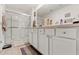 Clean and bright bathroom with a glass-enclosed shower, white cabinetry, and modern fixtures at 13765 Whiskey Daisy Dr, Dade City, FL 33525