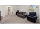 Comfortable bedroom with neutral carpet, a window for natural light, and ample space for a desk and seating at 13765 Whiskey Daisy Dr, Dade City, FL 33525