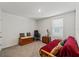 Versatile bedroom with futon, wooden chest, and chair, offering a flexible living space at 13765 Whiskey Daisy Dr, Dade City, FL 33525