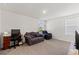 Comfortable bedroom with neutral carpet, a window for natural light, and ample space for a desk and seating at 13765 Whiskey Daisy Dr, Dade City, FL 33525