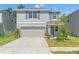 Charming two-story home with a two-car garage and well-maintained landscaping at 13765 Whiskey Daisy Dr, Dade City, FL 33525