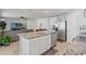 Modern kitchen with an island, stainless steel appliances, and an open layout leading to the living area at 13765 Whiskey Daisy Dr, Dade City, FL 33525
