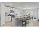Bright kitchen featuring an island with seating and views of the dining area and appliances at 13765 Whiskey Daisy Dr, Dade City, FL 33525