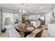 Open-concept kitchen featuring granite countertops, stainless appliances, and access to the living room and outdoor patio at 13765 Whiskey Daisy Dr, Dade City, FL 33525
