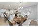 Bright kitchen and dining area with white cabinetry, granite countertops, and stainless steel appliances at 13765 Whiskey Daisy Dr, Dade City, FL 33525
