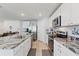 Well-lit kitchen featuring granite countertops, stainless steel appliances, and ample cabinet space at 13765 Whiskey Daisy Dr, Dade City, FL 33525