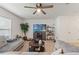 Inviting living room with plush seating, a modern entertainment center, and ample natural light at 13765 Whiskey Daisy Dr, Dade City, FL 33525