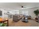 Open-concept living room with a large sectional sofa and adjacent kitchen with an island at 13765 Whiskey Daisy Dr, Dade City, FL 33525